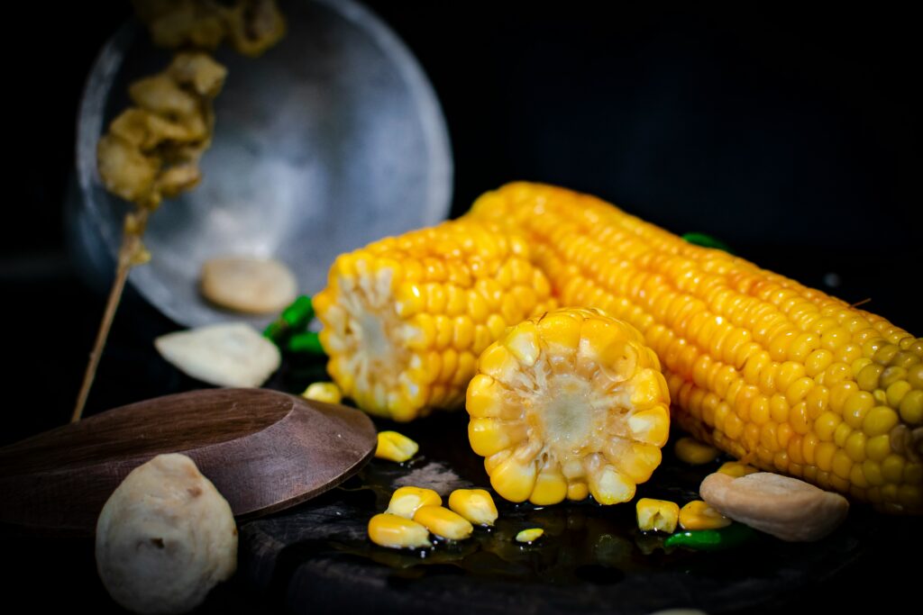 A Practical Guide to Cooking Corn on the Cob in the Microwave showing freshly cooked corn on the cob ready to serve with butter and seasoning.