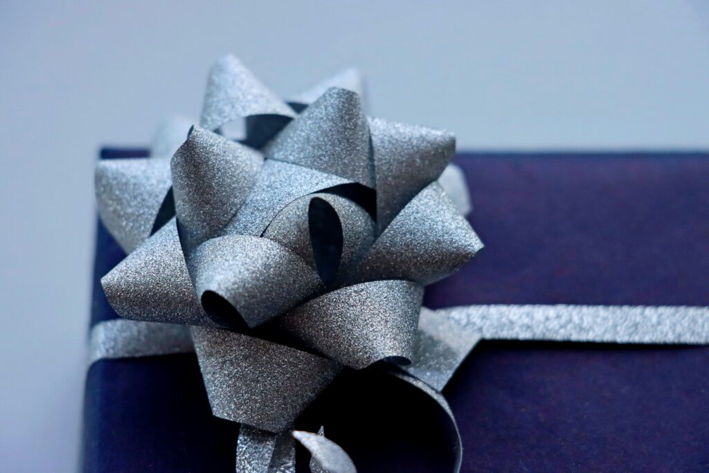 How to Make a Bow Out of Wrapping Paper covering paper folding, DIY bows, gift toppers, wrapping paper crafts, and handmade decorations.