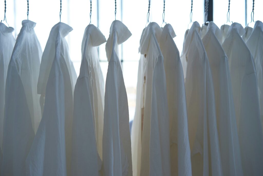 How to Get Yellow Stains Out of White Shirts covering sweat stains, deodorant buildup, fabric-safe cleaners, soaking, washing, and white clothing care.